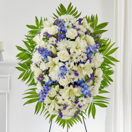 Standing floral spray of white flowers with blue and purple accents