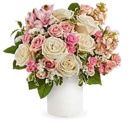 Pink and white rose bouquet in a white cylindrical vase
