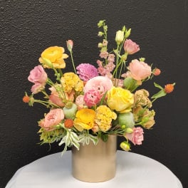 Mixed pastel bouquet in a gold cylinder vase
