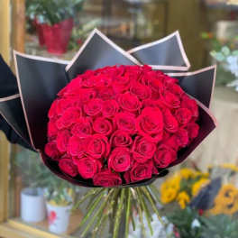 Bouquet of red roses wrapped in black paper