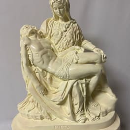 Cream-colored Pieta statue of Mary holding Jesus