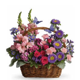 Colorful basket of pink roses, carnations, and purple daisies with decorative butterflies.