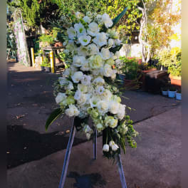 Tall white floral standing spray on an easel