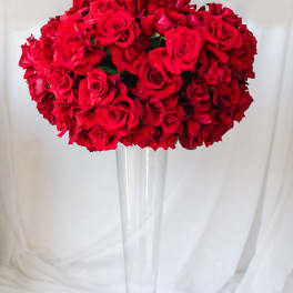 Red rose bouquet in a tall clear glass vase