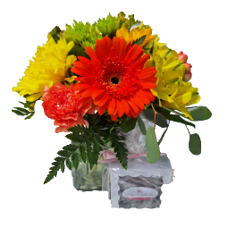 Bouquet of red, yellow, and pink flowers in a clear vase