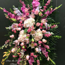 Large pink and white floral standing spray with lilies and roses