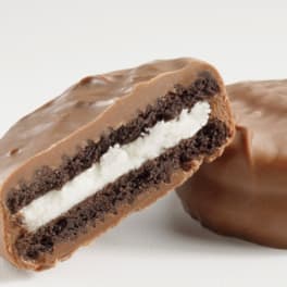 Chocolate-covered sandwich cookie with cream filling, one cookie cut open