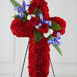 Red floral cross on a stand with blue and white accents