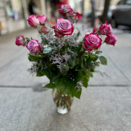 Pink roses arranged in a clear glass vase