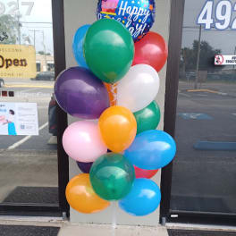 Colorful balloon bouquet with a Happy Birthday balloon on a stand