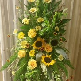 Tall floral spray with yellow roses and sunflowers