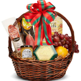 Gift basket with cheese, crackers, grapes, and fruit in a wicker basket