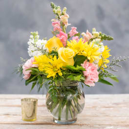 Yellow and pink mixed bouquet in a clear glass vase