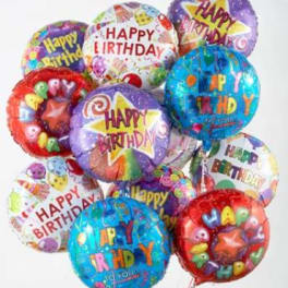 Cluster of colorful birthday balloons with printed messages