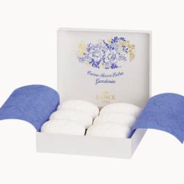 Box of white soaps with blue floral packaging
