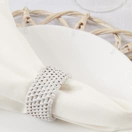 White napkin with a woven ring on a wicker placemat