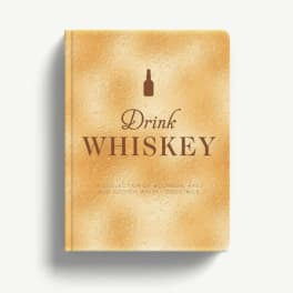 Gold book titled Drink Whiskey on a white background