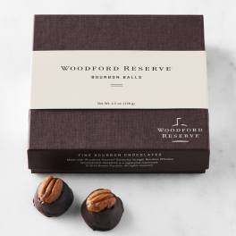 Box of Woodford Reserve bourbon balls with two chocolates in front