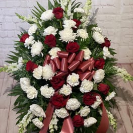 Large red and white floral spray with ribbon bow