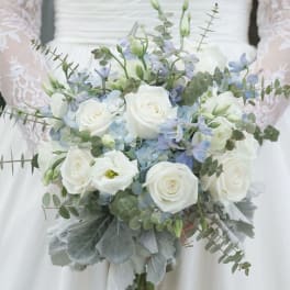 White rose bridal bouquet with pale blue flowers and eucalyptus