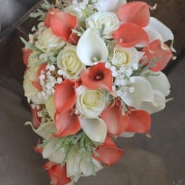 Bouquet of white roses and coral calla lilies