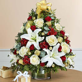 Christmas floral arrangement with white lilies and roses in a glass vase