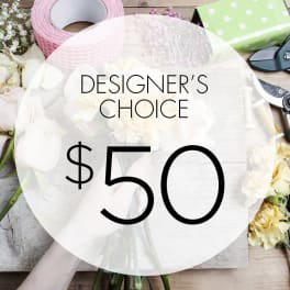 Designer’s choice floral arrangement with white blooms and craft supplies