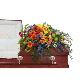 Colorful flower spray on a wooden casket