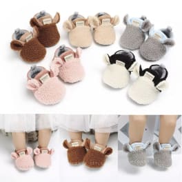 Plush animal slippers in several colors arranged on a white background.