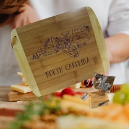 Wooden cheese board engraved with North Carolina map and text
