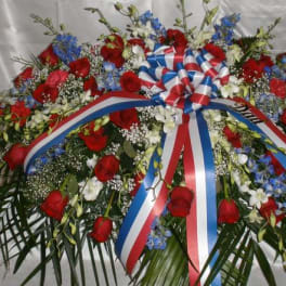 Large red, white, and blue floral wreath with ribbon bow