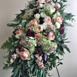 Large standing floral spray with roses, hydrangeas, and greenery