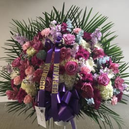 Large pink and purple floral standing spray with ribbon