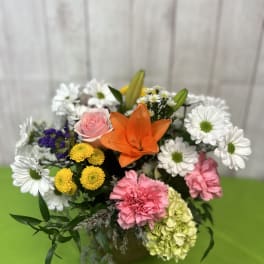 Mixed bouquet with orange lily, pink rose, white daisies, and carnations