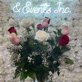 Bouquet of pink, white, and red roses in a glass vase