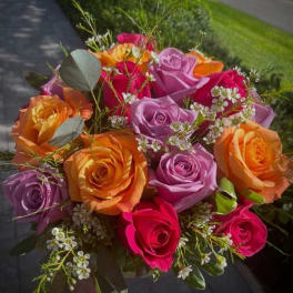 Bouquet of multicolored roses with small white filler flowers