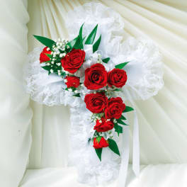 White lace cross with red roses and ribbon