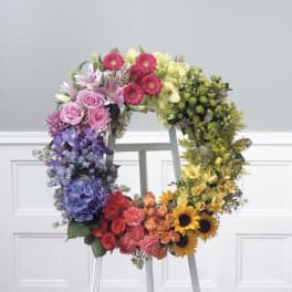 Colorful floral wreath with roses, lilies, hydrangeas, and sunflowers