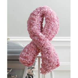 Pink floral awareness ribbon on a stand