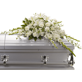 White floral casket spray with lilies and carnations
