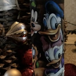 Disney character tumbler with holiday ornaments and pinecones