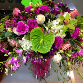 Large mixed bouquet with pink, white, and purple flowers in a vase