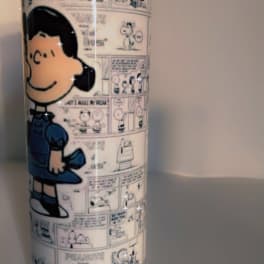 Tall tumbler with a Peanuts comic-strip design and Snoopy illustration