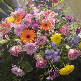 Mixed bouquet with pink roses, lilies, gerberas, and purple flowers