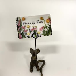 Decorative card holder with a floral business card and cat figurine base