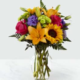 Bouquet of mixed flowers in a clear glass vase