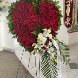 Heart-shaped red rose standing spray with white flowers and greenery