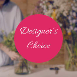 Pink circle with "Designer’s Choice" over a blurred florist workspace
