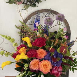 Colorful mixed flower arrangement with roses, calla lilies, and hydrangeas