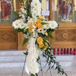 Standing floral cross with white chrysanthemums and yellow roses